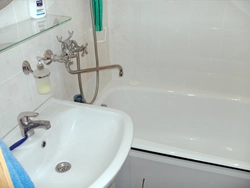 Bathroom with one faucet for bathtub and sink photo