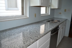 White granite countertop in the kitchen interior