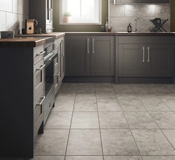 Gray porcelain tiles on the floor in the kitchen interior