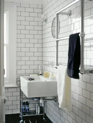 White bathtub with black grout photo