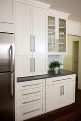 Handles on white kitchen facades photo