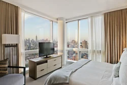 Bedroom design with panoramic windows in an apartment