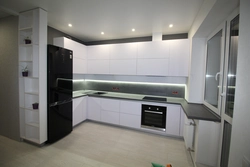 Kitchens with dark refrigerator photo