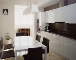 White kitchen interior with brown table