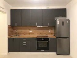 Photo of a gray kitchen combined with wood
