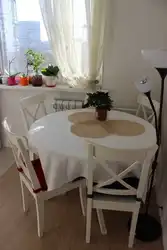 Photo of a round table for the kitchen against the wall