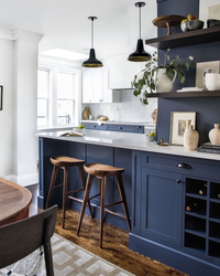 Blue kitchen in the interior photo with wooden