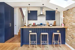 Blue kitchen in the interior photo with wooden