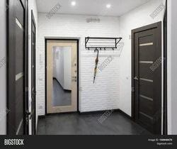 Hallway with front door with mirror photo