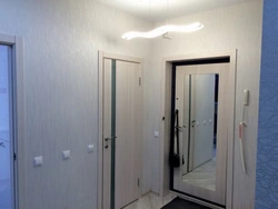 Hallway with front door with mirror photo
