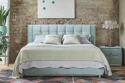 Turquoise Bed In A Bedroom Interior With A Soft Headboard