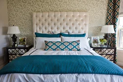 Turquoise bed in a bedroom interior with a soft headboard