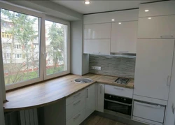 Window sill as a countertop in the kitchen photo in Khrushchev