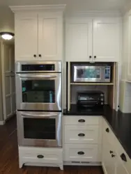 Photo of a kitchen with built-in oven and microwave