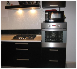 Photo of a kitchen with built-in oven and microwave