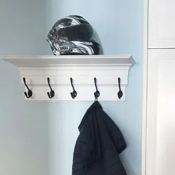 Shelf for hats in the hallway photo