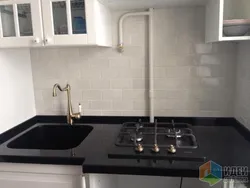 Sink And Stove Next To Each Other In The Kitchen Photo