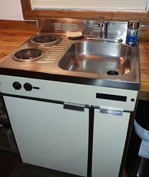 Sink and stove next to each other in the kitchen photo