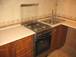 Sink and stove next to each other in the kitchen photo