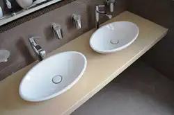 Bathroom sink overlay on the countertop photo of the bathtub