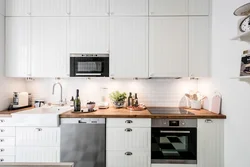 White kitchen black appliances photo wooden countertop