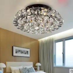 Modern chandelier under a suspended ceiling in the bedroom photo