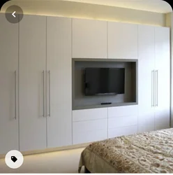 Full-wall bedroom wardrobe design with TV