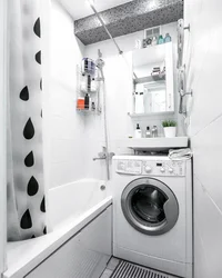 Bathroom design with a sink above the washing machine photo