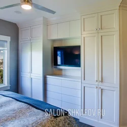 Wardrobe with TV in bedroom interior