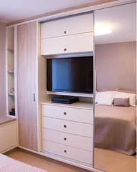 Wardrobe with TV in bedroom interior