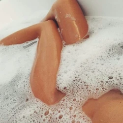 Photo Of Feet In A Bathtub Covered In Foam