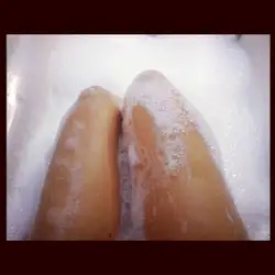 Photo of feet in a bathtub covered in foam
