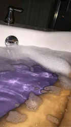 Photo of feet in a bathtub covered in foam