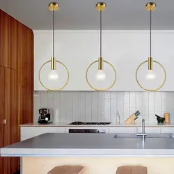 Pendant lamps above the bar counter in the kitchen in the interior