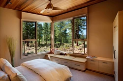 Bedroom design with a window in a wooden house