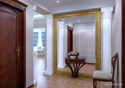 Hallway With A Mirror Opposite The Door Photo