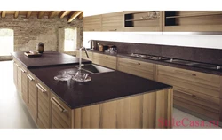 Photo of an oak kitchen with a dark countertop
