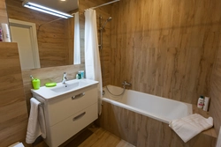 Bathtub with PVC wood panels photo
