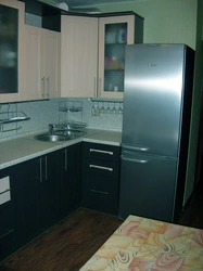 Corner kitchen design with refrigerator by the door