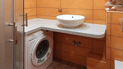 Bathroom design with countertop sink and washing machine