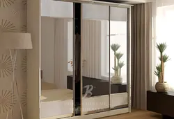 Bedroom wardrobe with mirror for three doors photo