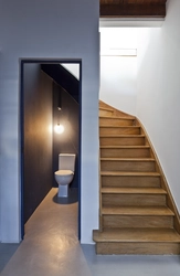 Bathroom design under the stairs in the house