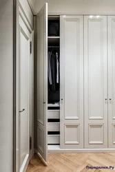 Built-in wardrobe in the hallway with hinged doors design