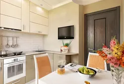 Corner kitchen interior with TV on the wall