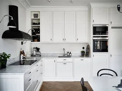 White kitchen with white countertops and white appliances photo
