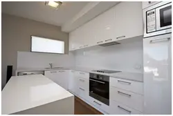 White Kitchen With White Countertops And White Appliances Photo