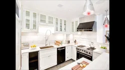 White kitchen with white countertops and white appliances photo