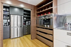 Kitchen design with built-in appliances and refrigerator