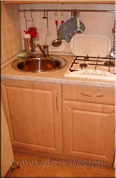 Stove and sink in a small kitchen photo