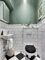 Bathtub with white tiles and gray grout photo
